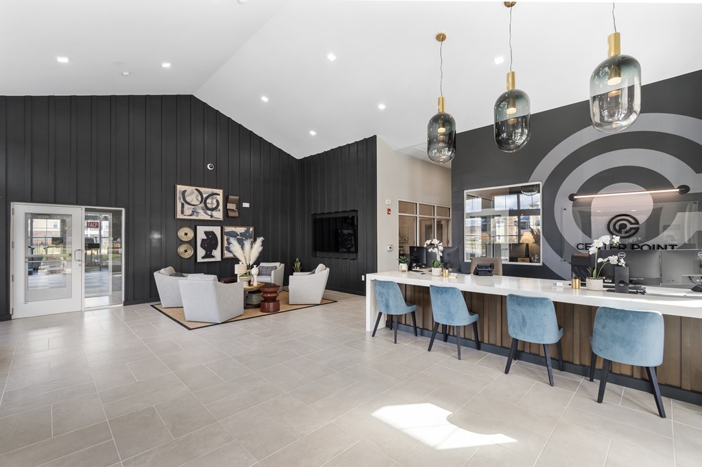 A modern dining room with a long table and chairs.