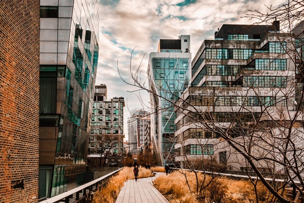 a person walking down a sidewalk in a city