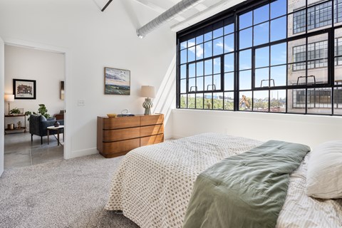 Bedroom with historic steel factory windows overlooking Cole Noble
