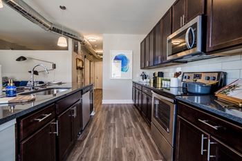 Fully Equipped Kitchen Includes Frost-Free Refrigerator, Electric Range, & Dishwasher at The Congress at Library Square, Indianapolis, IN