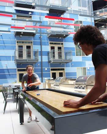 Playing On Shuffleboard at The Congress at Library Square, Indianapolis, IN