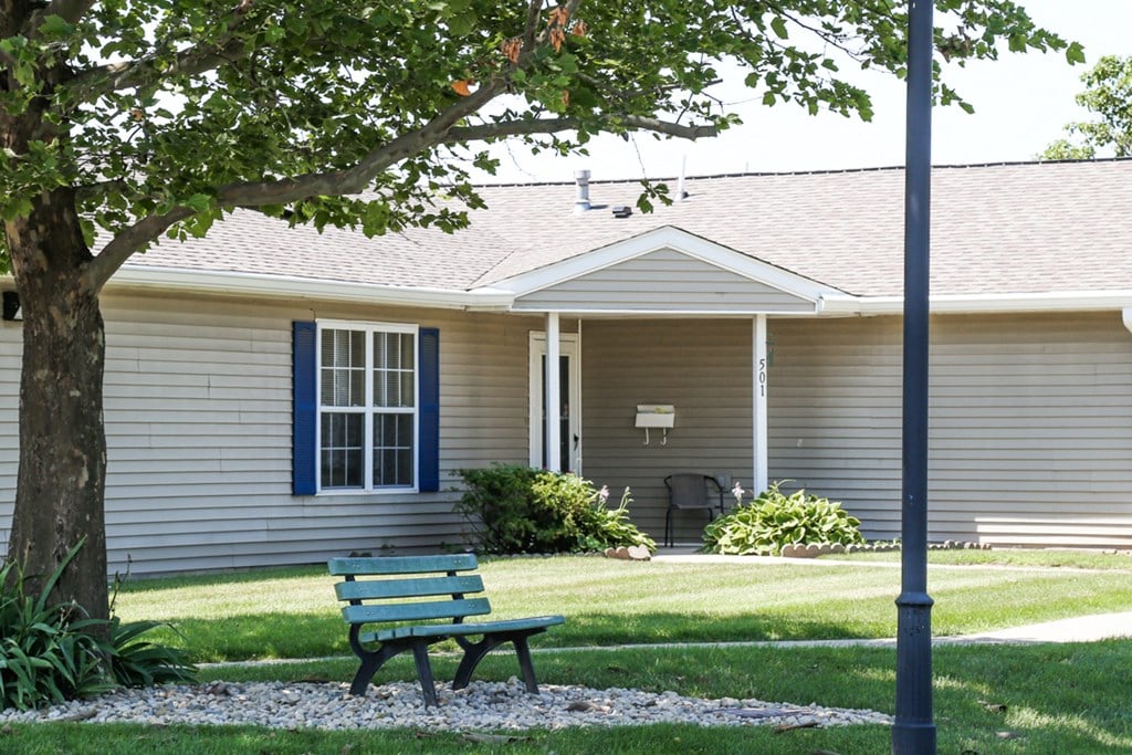 bench and trees outside of first floor apartment