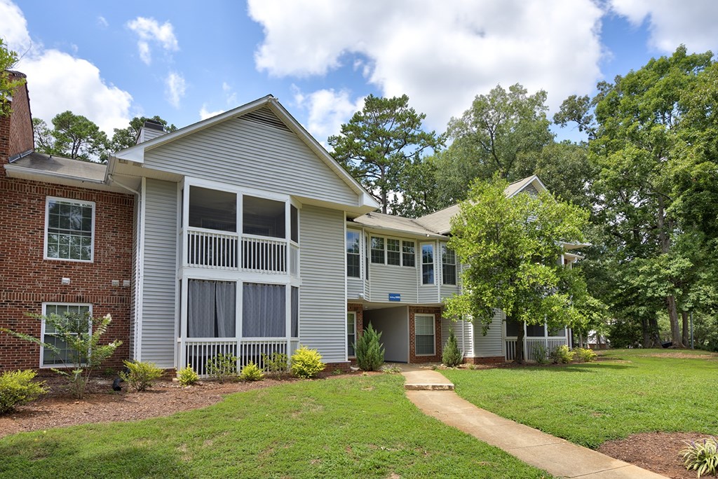 A house with a grey roof and a white fence.