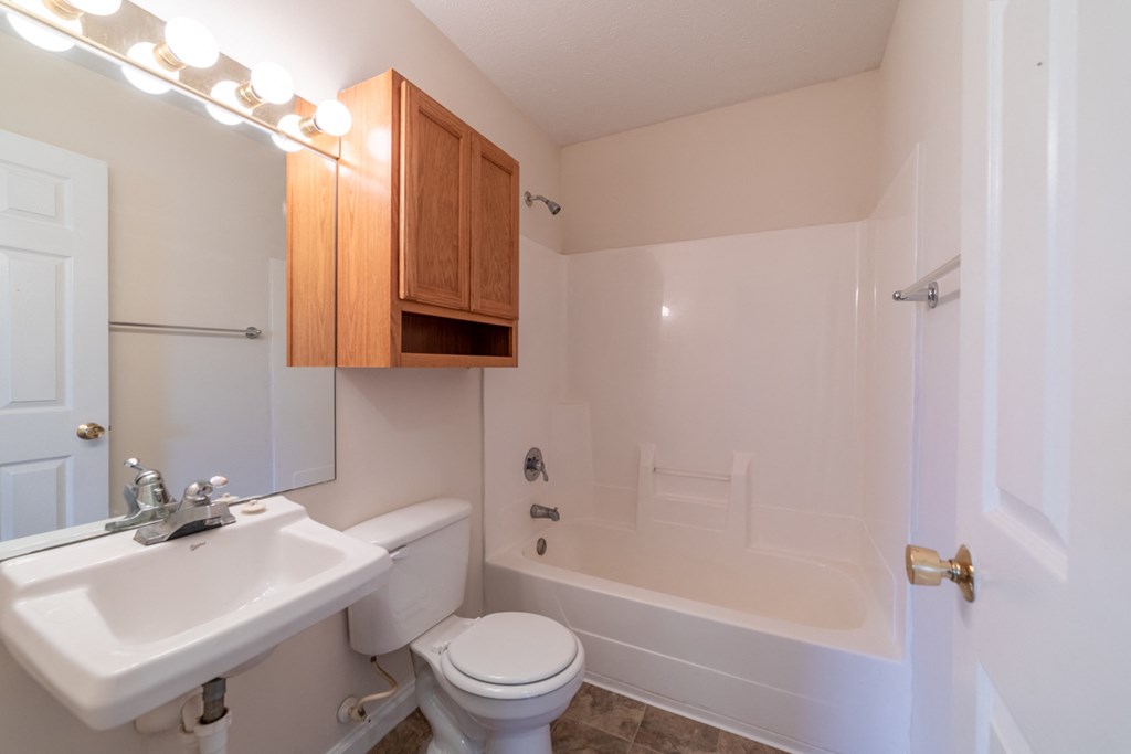 a bathroom with a sink toilet and bathtub