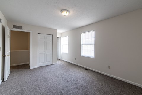 a bedroom with a door and a window