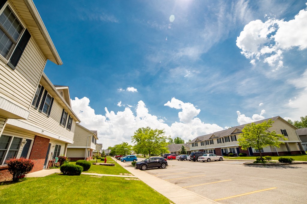 a view of a parking lot in front of an apartment complex