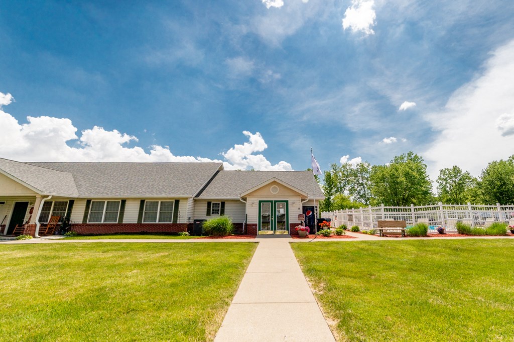 a home with a walkway leading to the front door