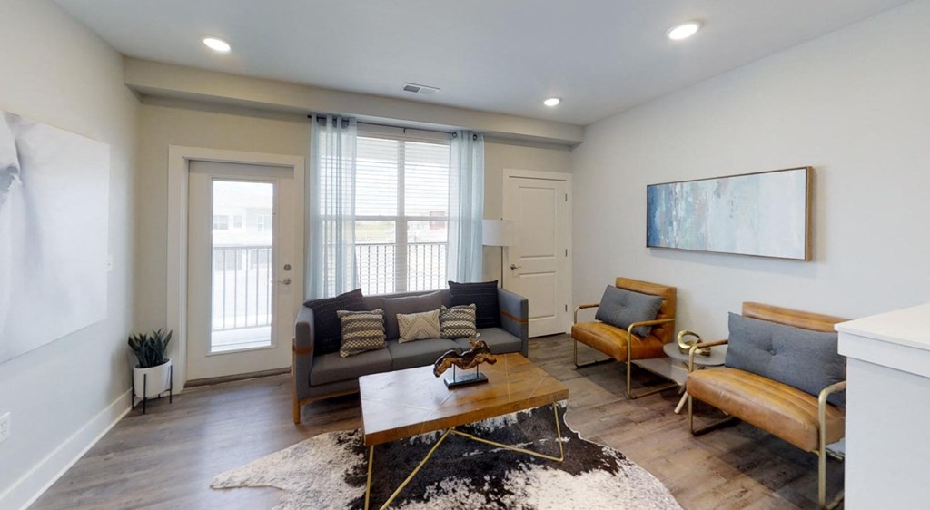 a living room with couches and a coffee table at Echo Park at Perry Crossing Apartments, Indiana