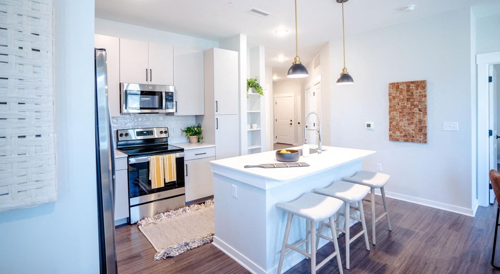 a kitchen with an island and stools