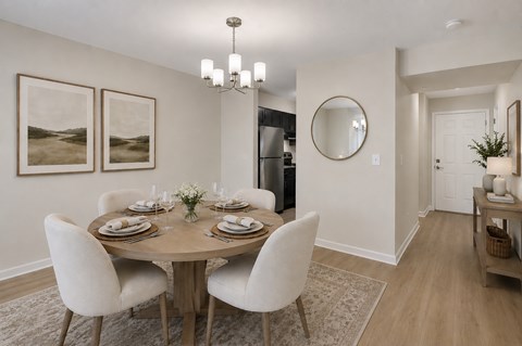 A dining room with a round table set for six.