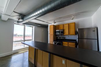 Kitchen Island at Janus Lofts, Managed by Buckingham Urban Living, Indiana, 46225