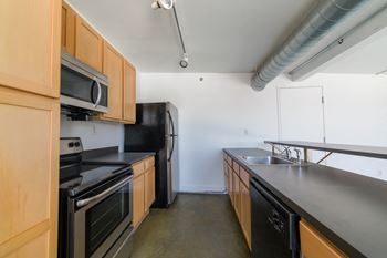 Chef-Inspired Kitchens Feature Stainless Steel Appliances at Janus Lofts, Managed by Buckingham Urban Living, Indianapolis, IN, 46225