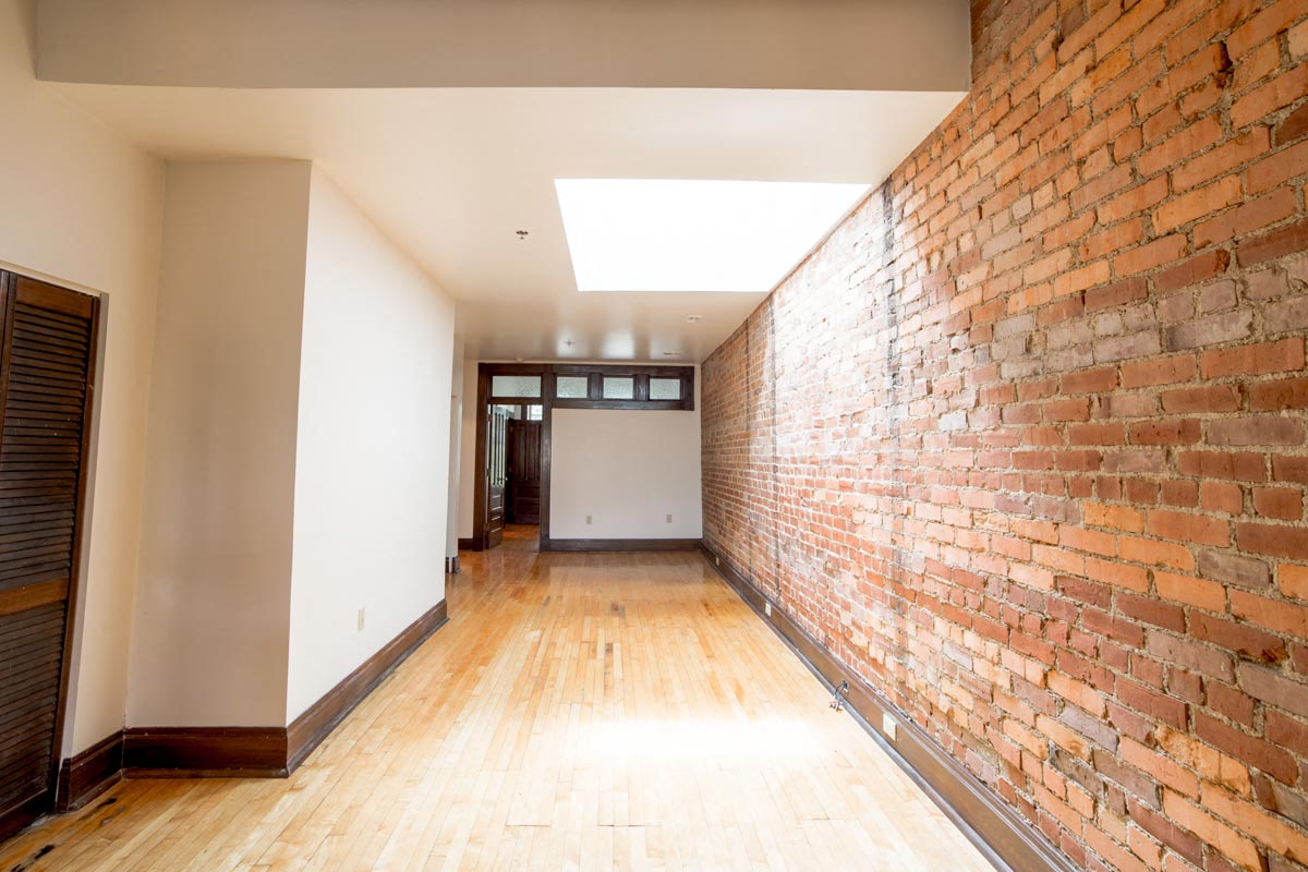 Living Area space with Exposed Brick at Lockerbie Court on Mass Ave, Indianapolis