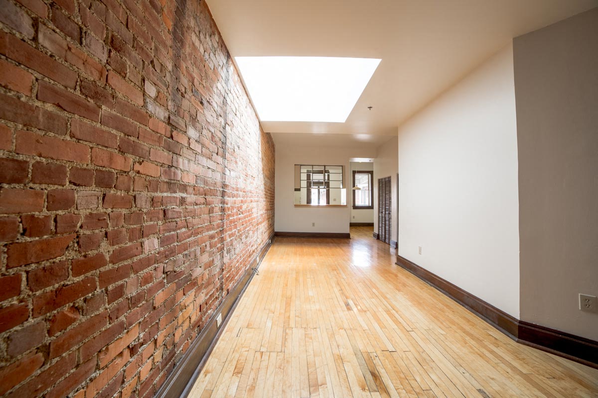 Living Area with Exposed Brick at Lockerbie Court on Mass Ave, Indiana