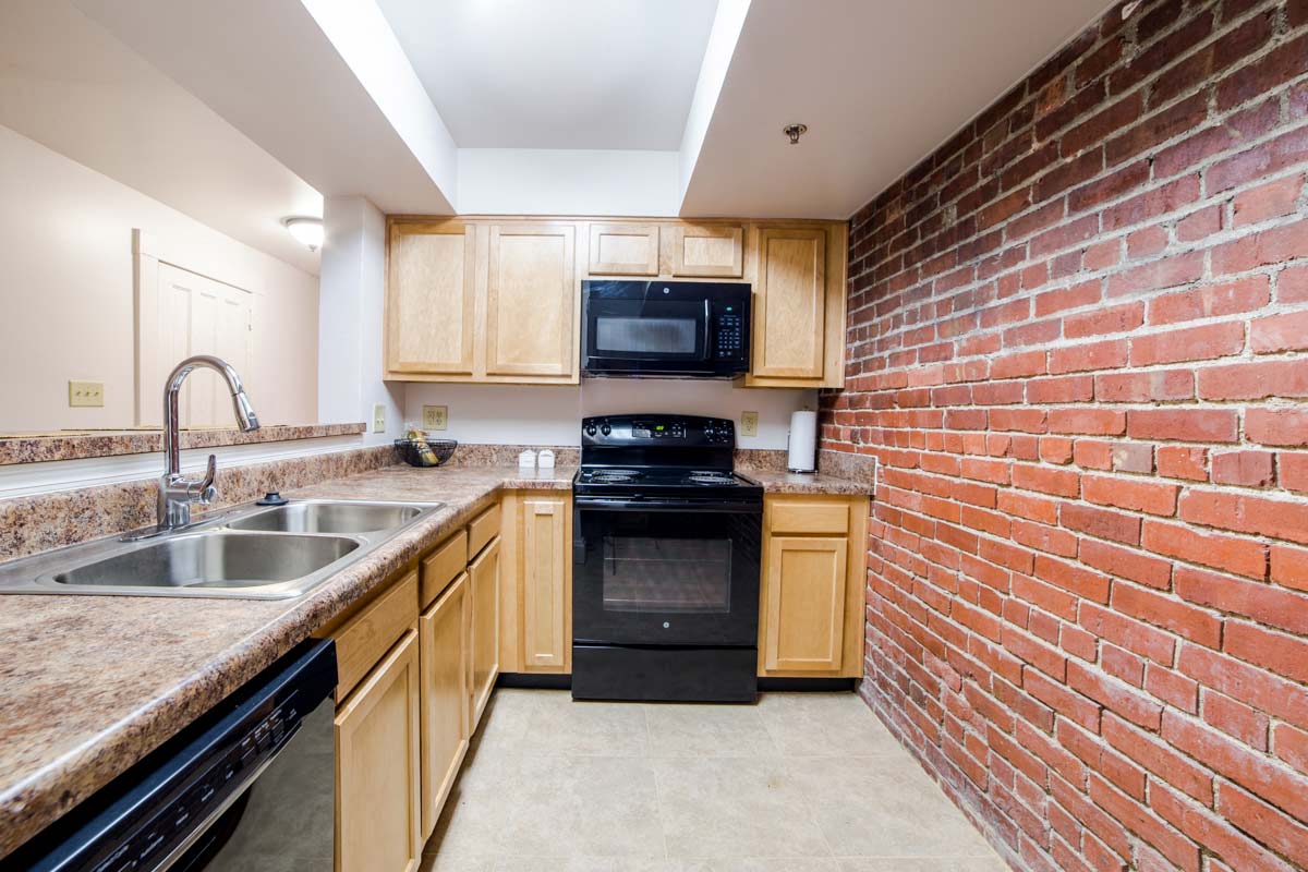 Modular Kitchen with Black Appliances wide view at Lockerbie Court on Mass Ave, Indianapolis, Indiana