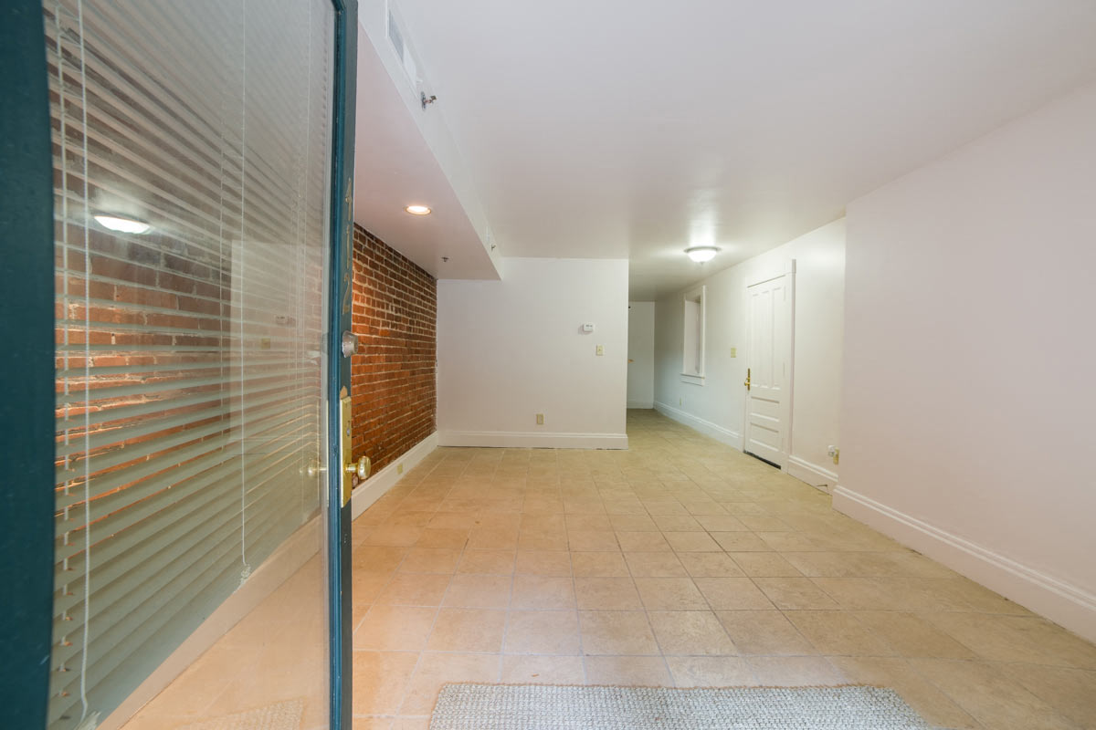 Living Area with Exposed Brick wide angle at Lockerbie Court on Mass Ave, Indiana