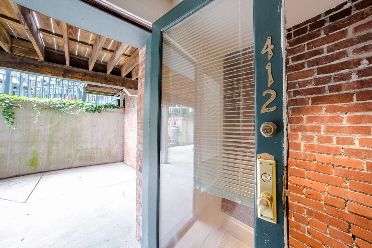 Outdoor Patio Space with Door view and exposed Brick inside at Lockerbie Court on Mass Ave, Indiana, 46204