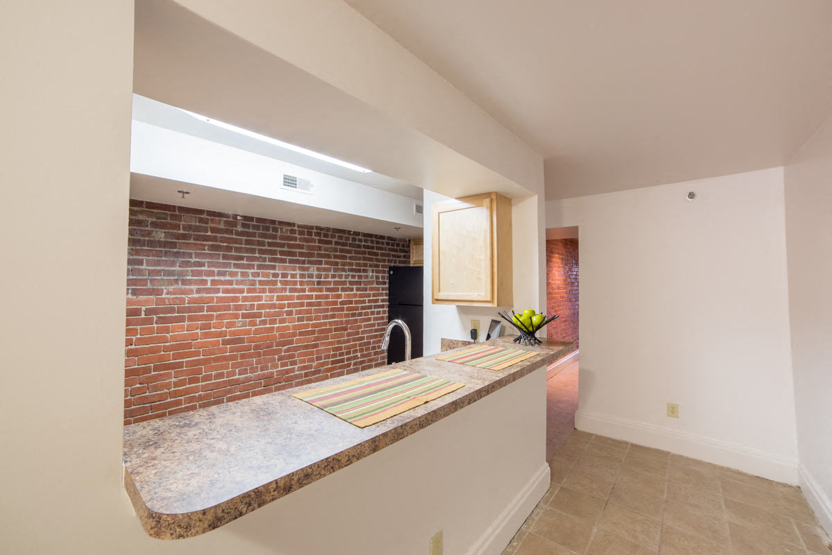 Modular Kitchen with Black Appliances wide view and Living room view at Lockerbie Court on Mass Ave, Indianapolis, IN, 46204