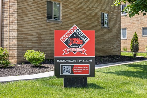 Monon Court Apartments sign in Broad Ripple, IN advertising vintage one- and two-bedroom apartments within walking distance of the Monon Trail.