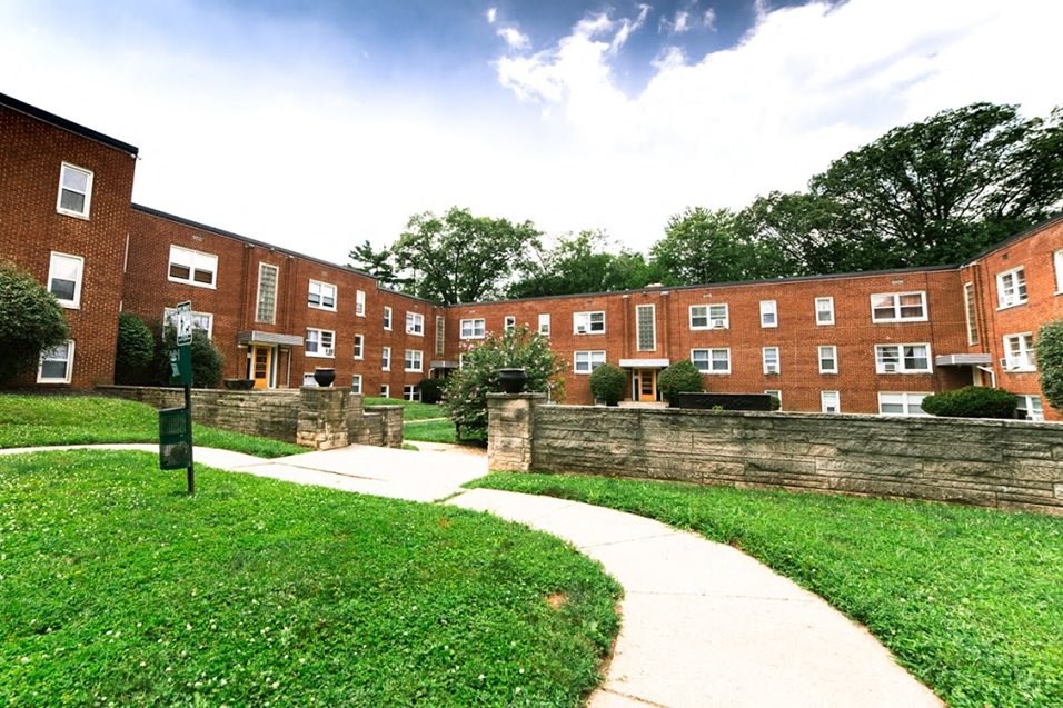 a sidewalk in front of a brick building