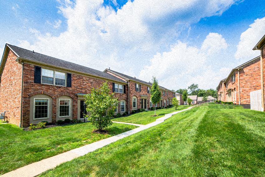 a row of brick apartment buildings on a sunny day