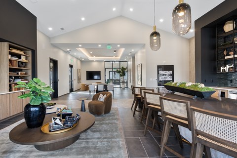 A modern living room with a dark wood coffee table and chairs.