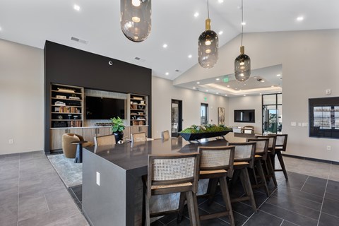 A modern kitchen with a dining table and chairs.