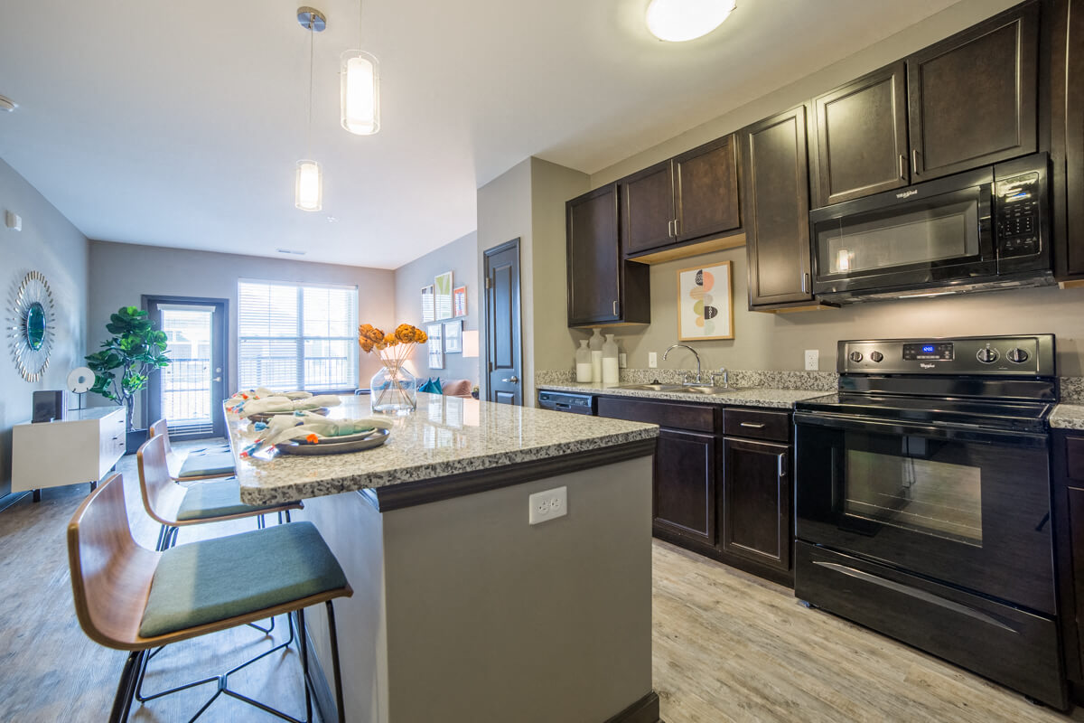 A kitchen with a black oven and microwave.