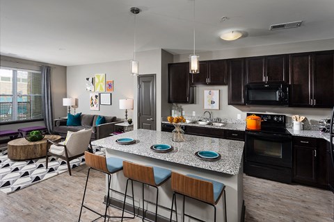 A kitchen with a bar area and a dining table.