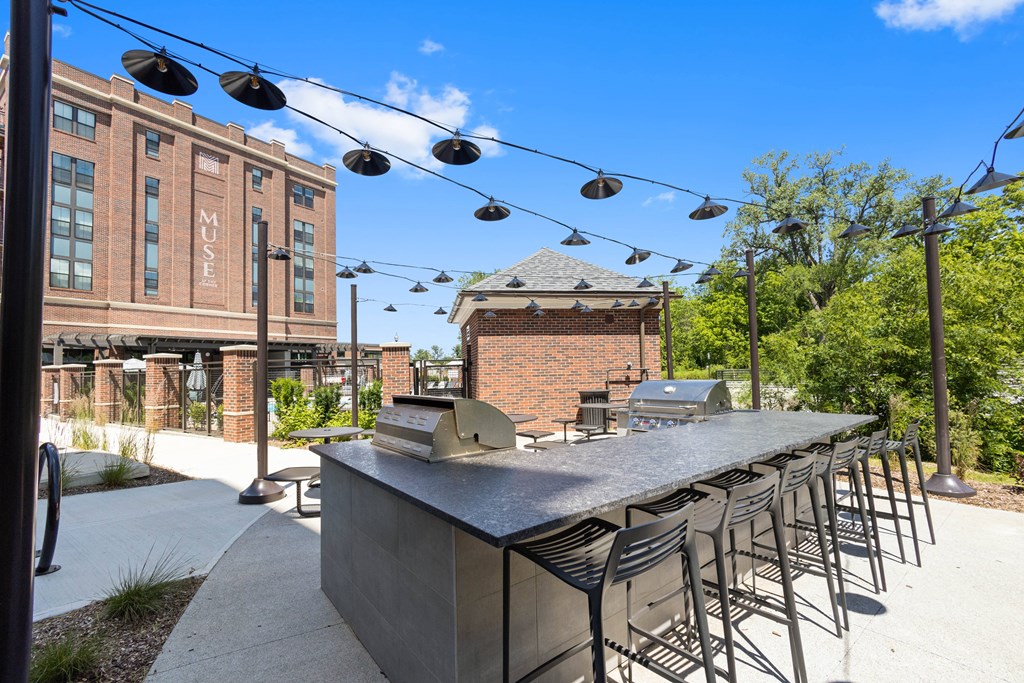 a communal bar with chairs and a building in the background
