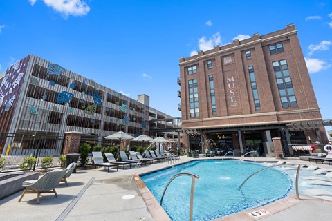 a swimming pool in front of a brick building