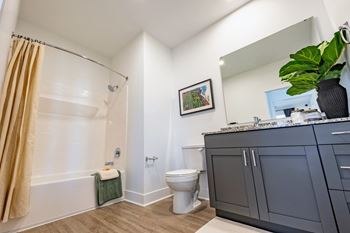 Spacious bathroom at Montage West Lafayette with granite countertops and modern cabinetry.
