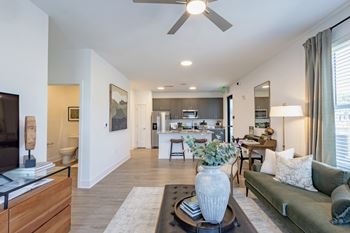 Apartment living room and kitchen at Montage West Lafayette with modern finishes.