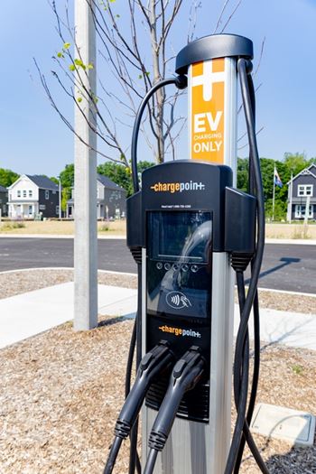 An electric vehicle charging station with the sign ChargePoint.