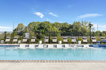 Poolside loungers line the modern swimming pool area at Montage West Lafayette, perfect for sunbathing and enjoying the Indiana summer. at Montage West Lafayette Apartments, Indiana, 47906