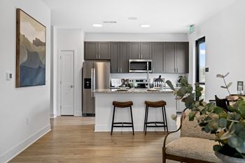 Modern apartment kitchen at Montage West Lafayette with stainless-steel appliances and granite countertops.