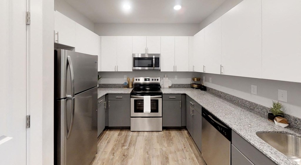 a kitchen with stainless steel appliances and granite counter tops at Echo Park at Perry Crossing Apartments, Plainfield, 46168