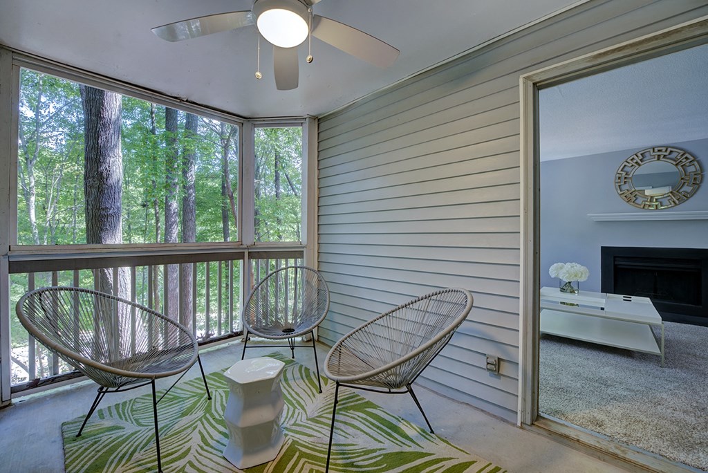 A room with a ceiling fan and a fireplace.