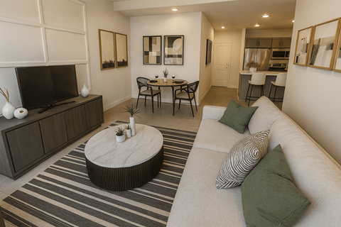 A living room with a white couch and a coffee table.