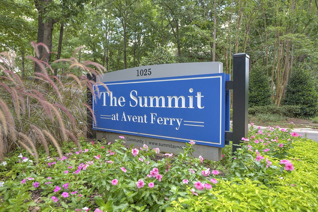 A blue sign that says The Summit at Avent Ferry.