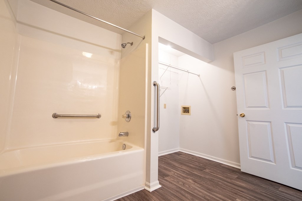 a bathroom with a bathtub and a door