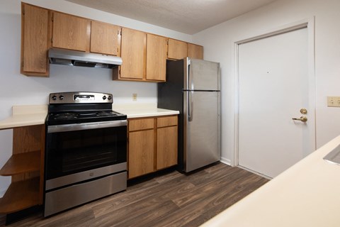 a kitchen with stainless steel appliances and wooden cabinets