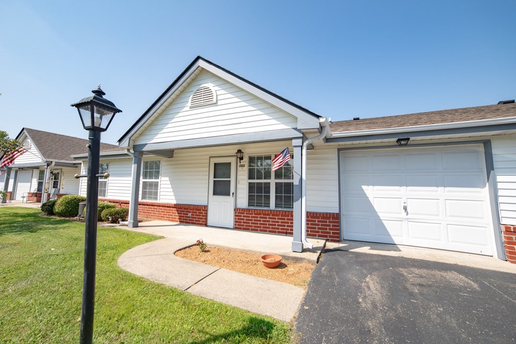 a house with a flag on a pole in front of it