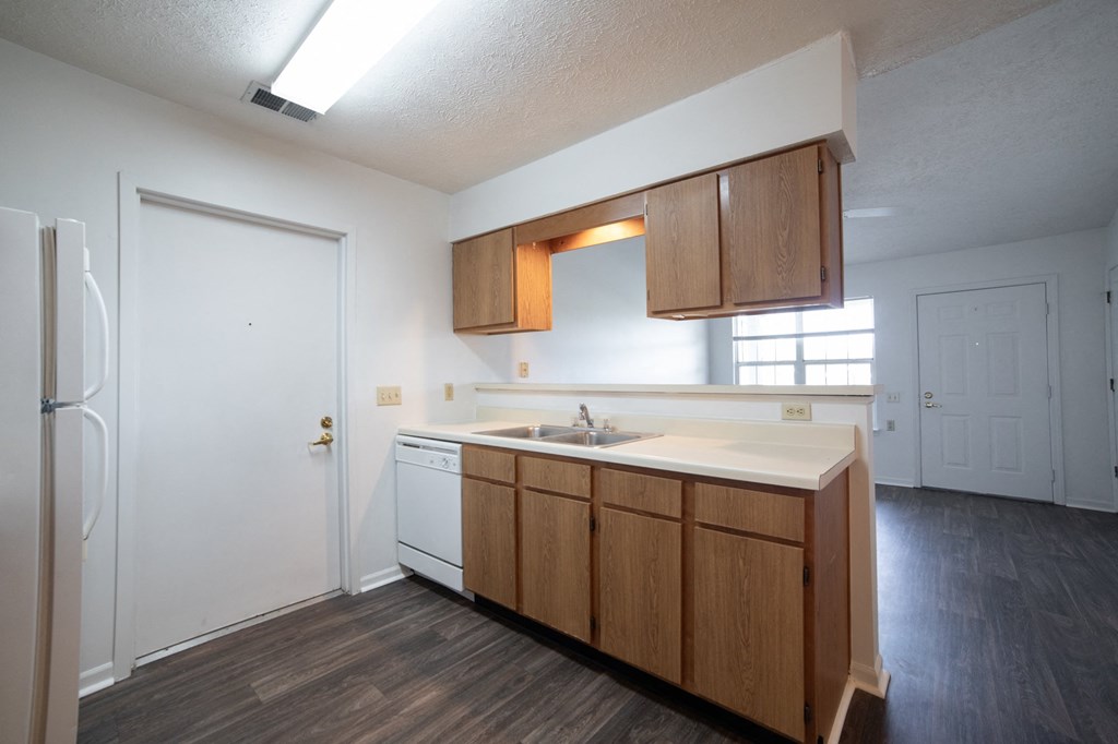 a kitchen with white appliances and wooden cabinets