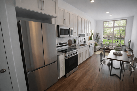 A modern kitchen with a stainless steel refrigerator and a dining table with chairs.