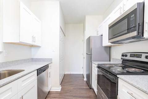 a kitchen with white cabinets and stainless steel appliances