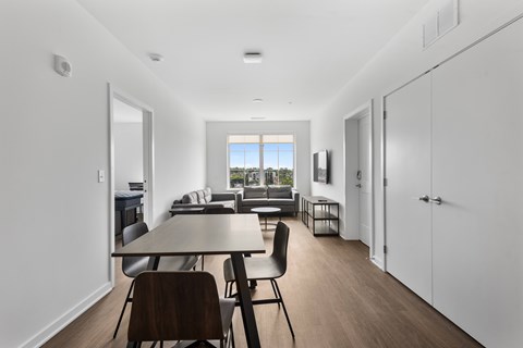 A modern dining room with a table and chairs.