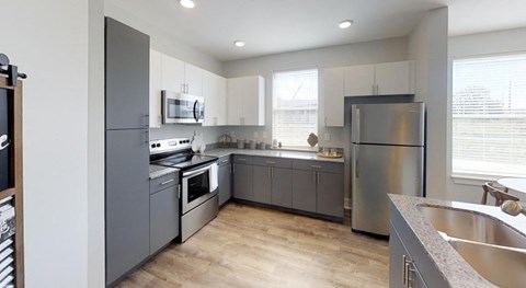 a kitchen with stainless steel appliances and white cabinets