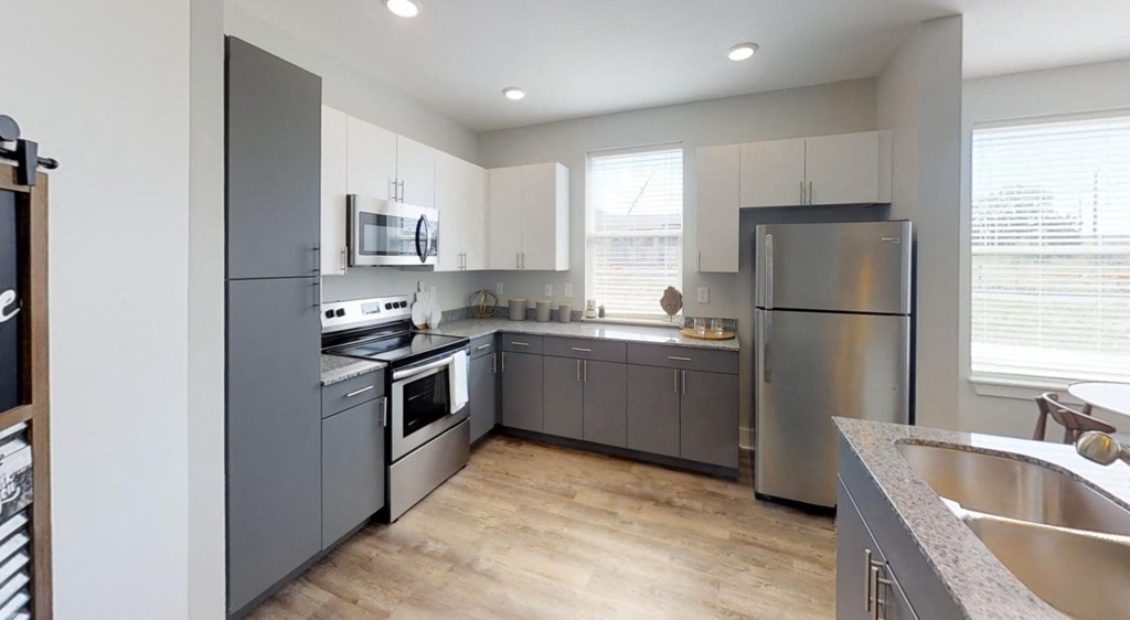 a kitchen with stainless steel appliances and white cabinets a kitchen with stainless steel appliances and white cabinets at Echo Park at Perry Crossing Apartments, Indiana, 46168