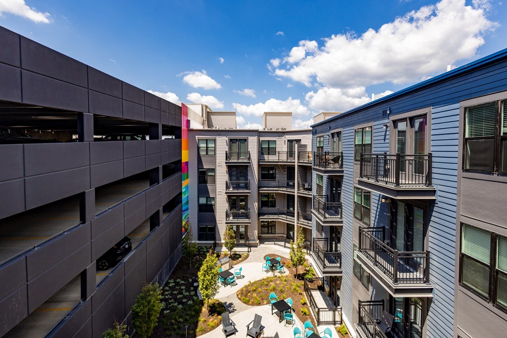 a view of a courtyard in a mix of apartment buildings
